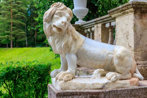 Marble statue of the lion on large stone staircase in Pavlovsk P
