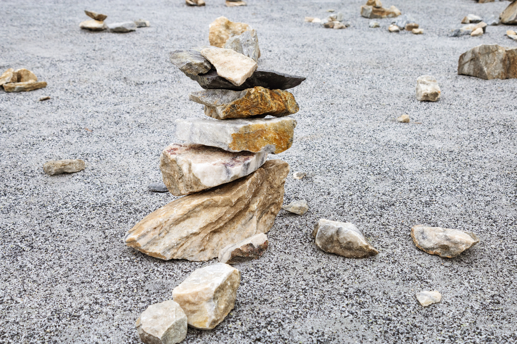 Marble stones piled on top of each other in  form of tall tower.