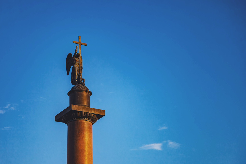 Close up of Alexander column top on Palace square background of blue sky