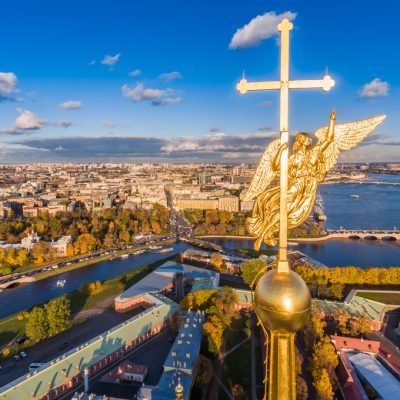 Russia, St. Petersburg, Aerial landscape of Peter and Paul cathedral at sunset, walls of fortress, Golden autumn, panorama landscape, golden spire with cross and angel, drawbridges, river Neva