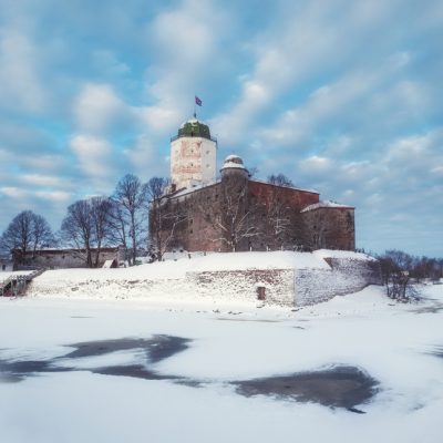 Castle in the city of Vyborg in snowy winter against the blue sky