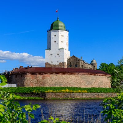 Medieval fortress in Vyborg. Castle on the water against the blu