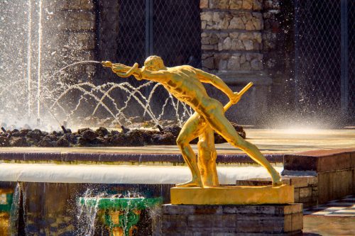 Statue of a youth with a snake at the main fountain of Peterhof