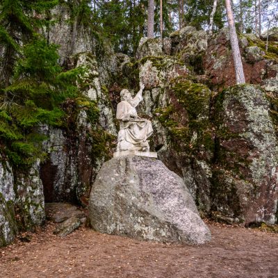 Vainamoinen playing on a kantele - statue of the hero of the epic Kalevala. Vyborg. Monrepos park.