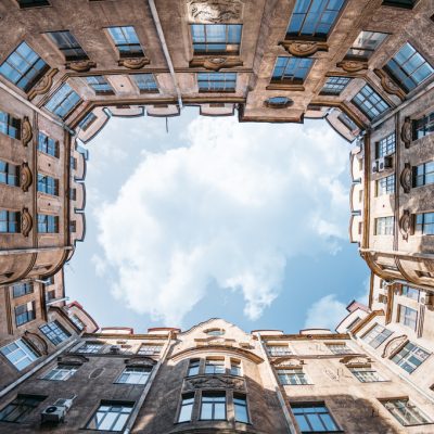 enclosed-courtyard-of-old-residential-house-in-saint-petersburg-russia-blue-cloudy-sky-copy-space
