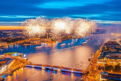 Grand fireworks over the waters of the Neva River in St. Petersburg, visible Palace Bridge, Peter and Paul Fortress.