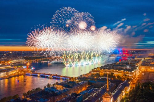 Grand fireworks over the waters of the Neva River in St. Petersburg, visible Palace Bridge, Peter and Paul Fortress.