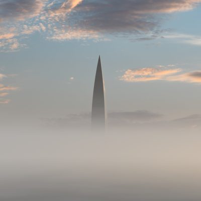 Skyscraper at sunrise on a foggy morning. Minimalistic landscape