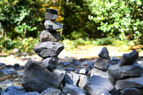 stack-rocks-forest-with-green-tree-background